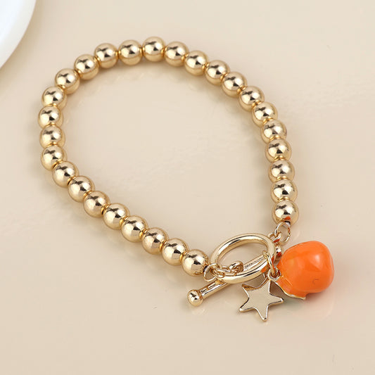 Faux Gold T-Bar Bracelet with Enamel Orange Fruit and Star Charms