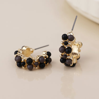 Clara golden cluster hoop earrings in black and gold